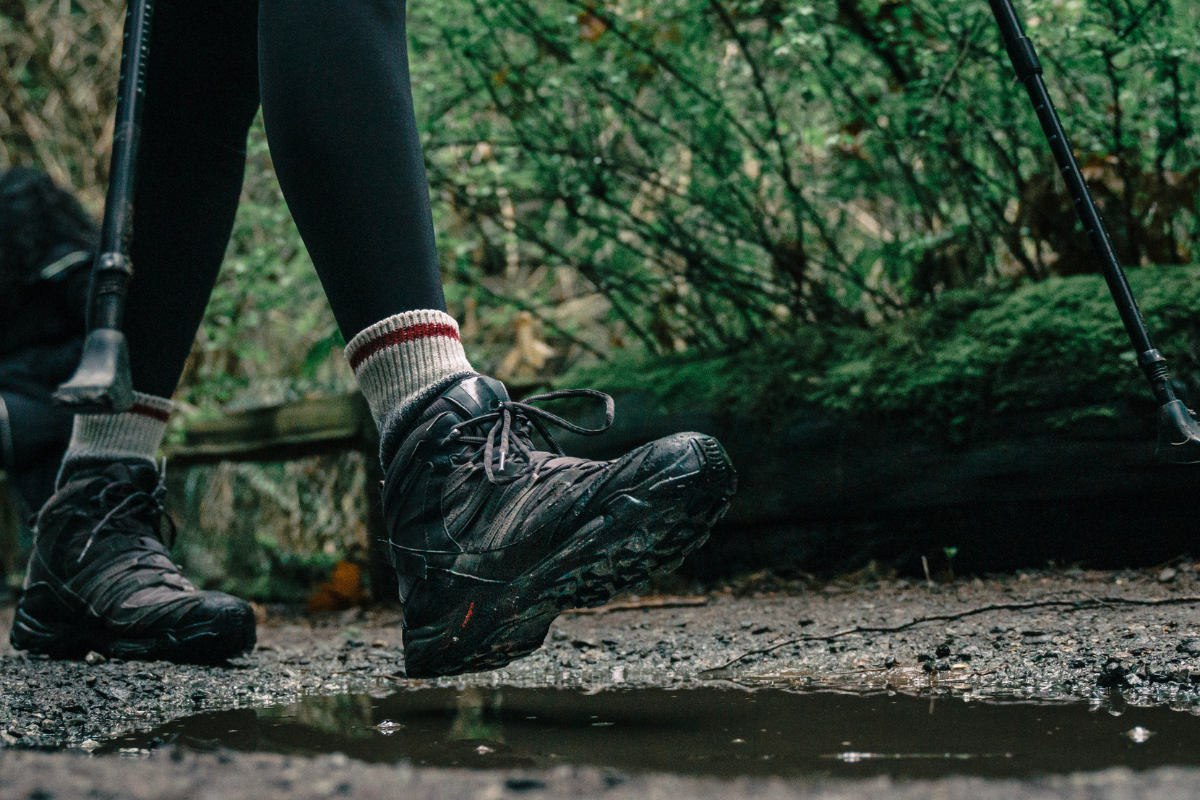 "A person carefully walking on a slippery road, highlighting the challenges of maintaining balance on wet or icy surfaces."