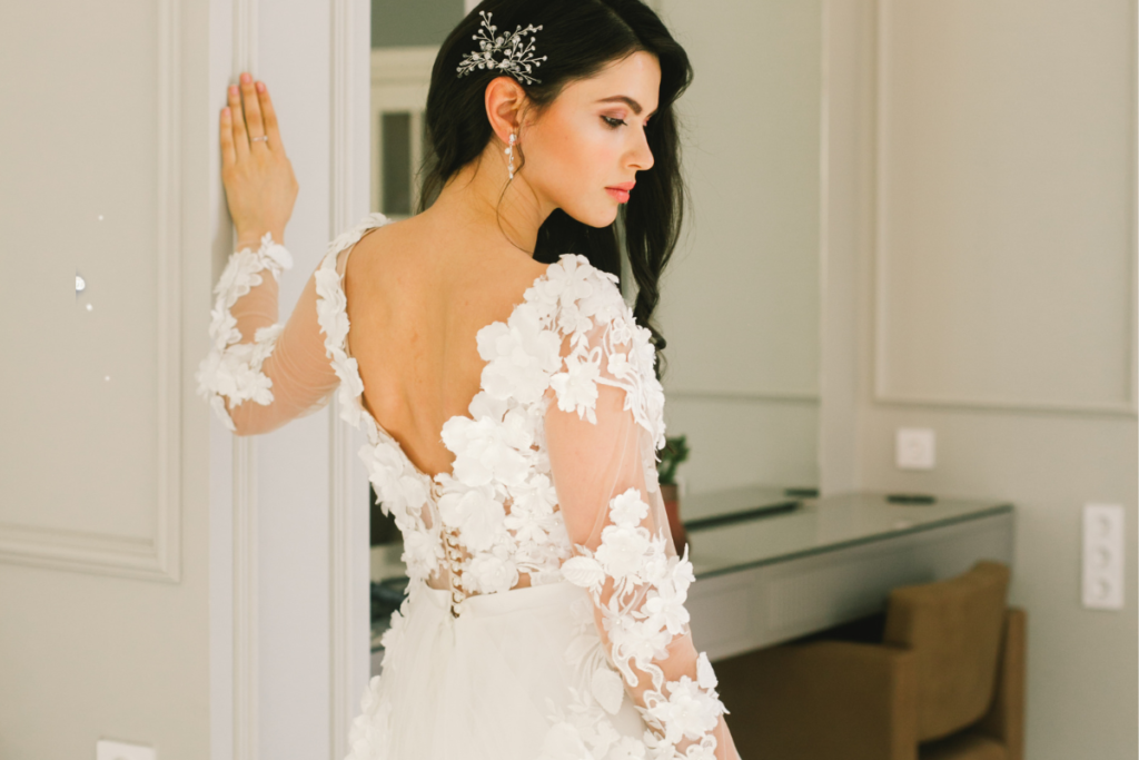 Bride wearing a Cleopatra vintage 1920s wedding dress with delicate lace details and classic 1920s-inspired elegance.