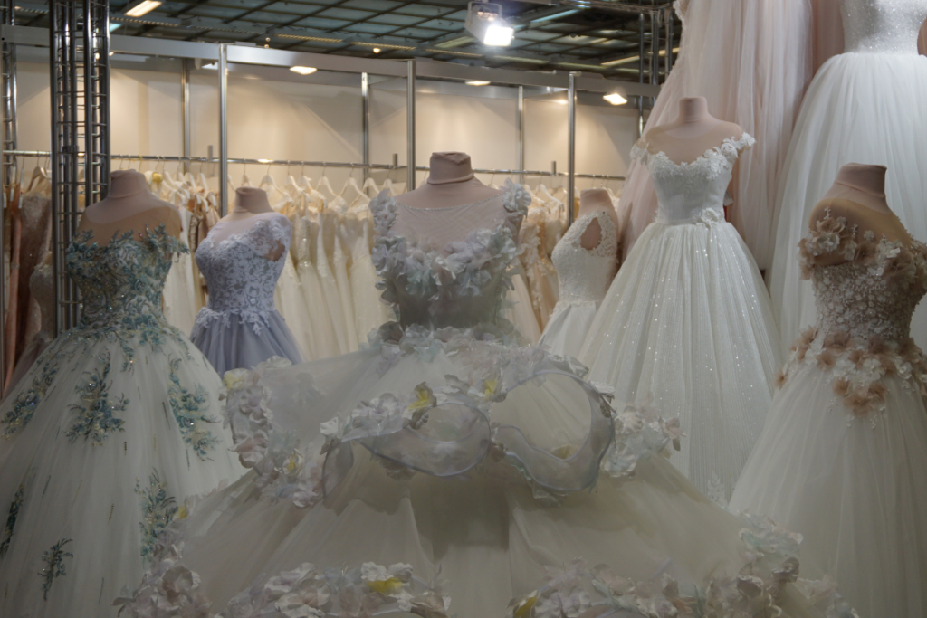 Display of vintage wedding dresses, including Cleopatra-inspired 1920s designs with lace details and classic 1920s dress styles in a bridal shop